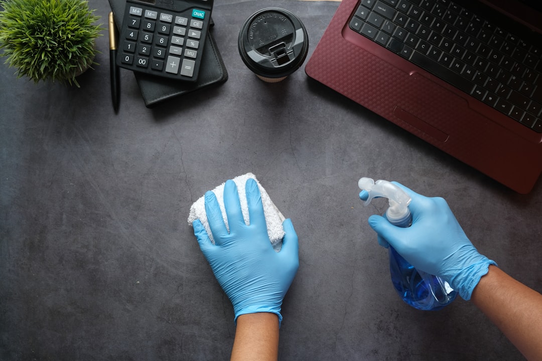 individual-dressed-in-blue-long-sleeve-shirt-sitting-next-to-a-black-laptop-9gpkrsbgmc